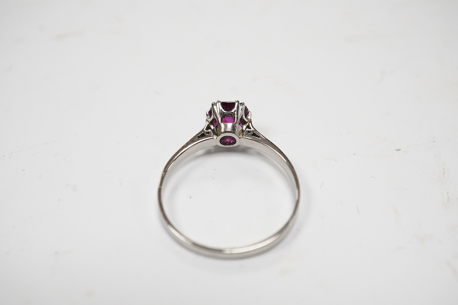 A white metal (stamped plat) and solitaire ruby set ring, size L, gross weight 2.2 grams. Condition - poor to fair